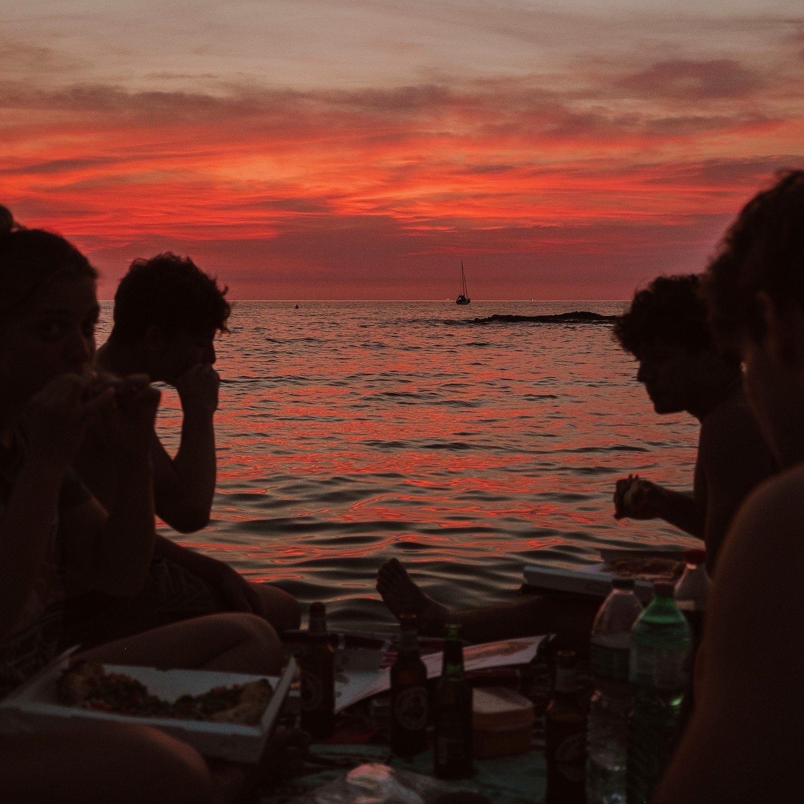 Friends watching the sunset over the sea in Valencia